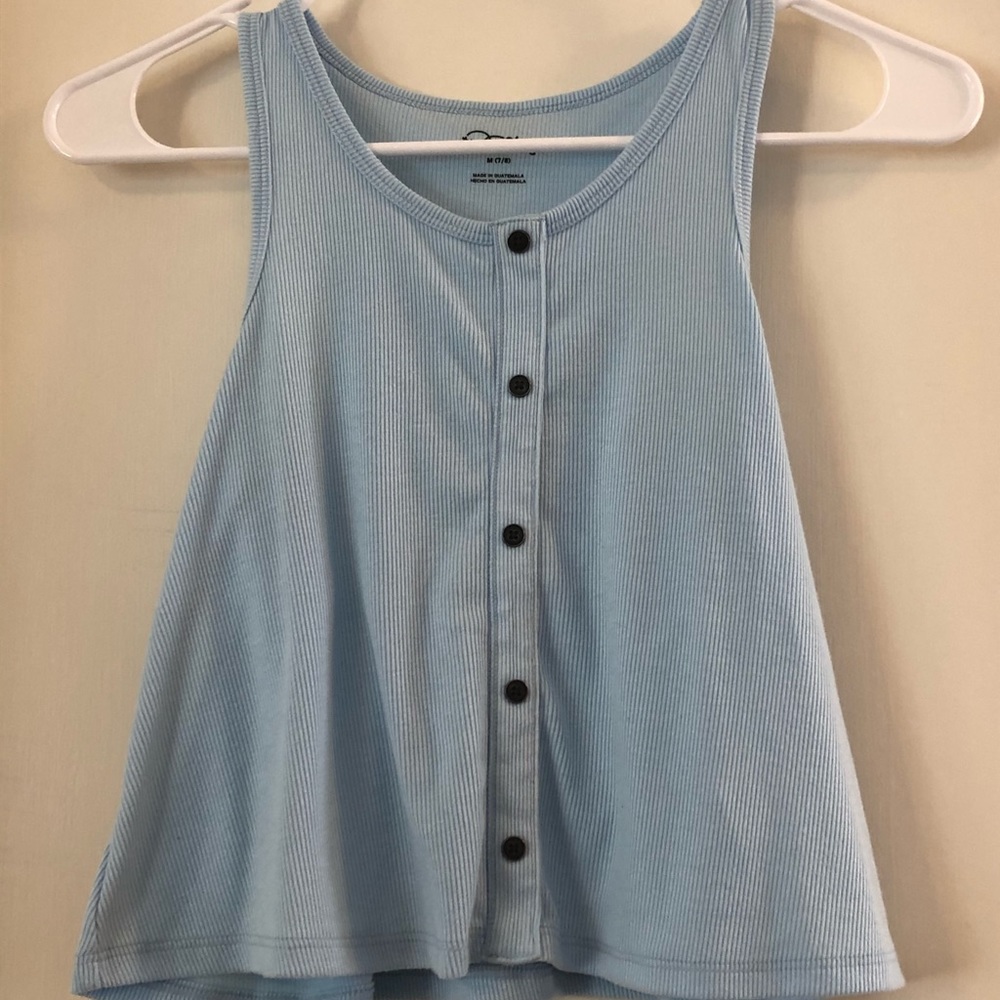 A light blue tank top with black buttons